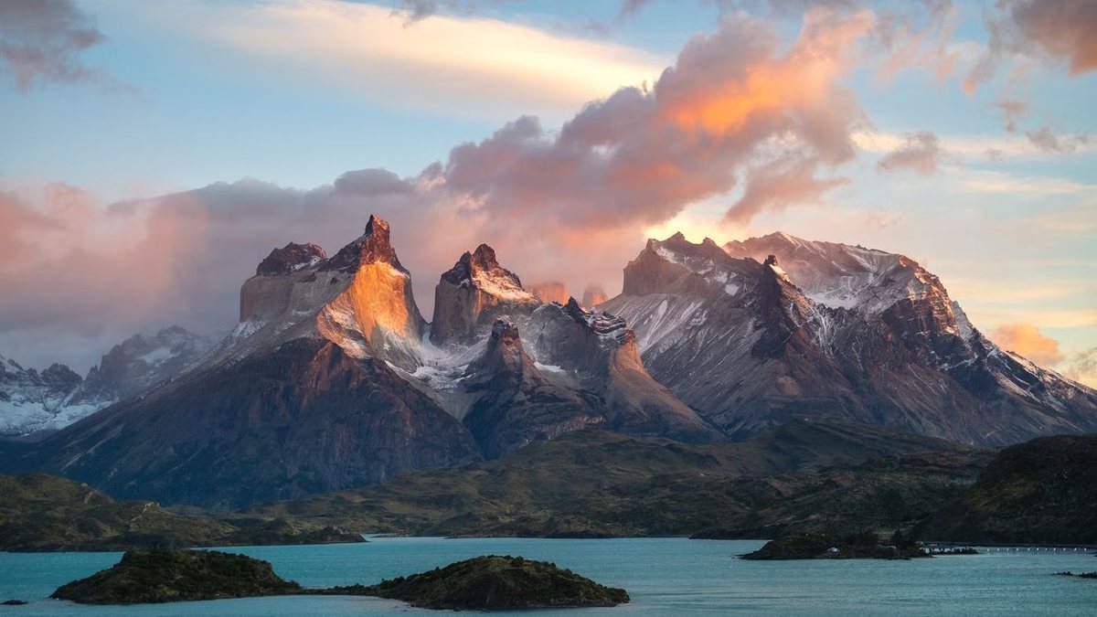 Sunset light on the granite horns of Torres del Paine above a turquoise lake